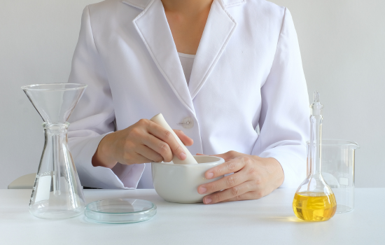 person at a table with lab equipment